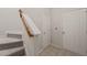 Hallway with carpeted stairs and two white doors at 4703 Kings Garden Rd, Raleigh, NC 27612