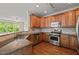 Kitchen with wood cabinets, stainless steel appliances, and granite countertops at 4703 Kings Garden Rd, Raleigh, NC 27612