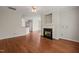 Living room featuring hardwood floors, a fireplace, and an opening to the kitchen at 4703 Kings Garden Rd, Raleigh, NC 27612