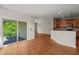 Open-concept living space with hardwood floors, sliding door to balcony, and seamless flow for modern living at 4703 Kings Garden Rd, Raleigh, NC 27612