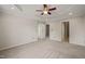 Spacious carpeted main bedroom features a tray ceiling and multiple doors at 4703 Kings Garden Rd, Raleigh, NC 27612