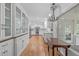 Elegant kitchen with white cabinets, stainless steel appliances, and hardwood floors at 4830 North Hills Dr, Raleigh, NC 27612