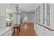 Open kitchen with hardwood flooring leading to Gathering room with fireplace at 4830 North Hills Dr, Raleigh, NC 27612