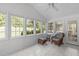 Light-filled sunroom with multiple windows, tile floor, and access to the exterior at 4830 North Hills Dr, Raleigh, NC 27612