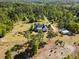 Stunning overhead shot featuring a home with a shed, garden, and circular driveway, all framed by lush greenery at 494 Asset Pkwy, Sanford, NC 27332
