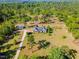 Overhead view of home featuring a long driveway, storage shed, and generous green space surrounded by mature trees at 494 Asset Pkwy, Sanford, NC 27332