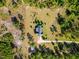 An aerial shot of a home surrounded by trees features a detached shed and a circular driveway at 494 Asset Pkwy, Sanford, NC 27332