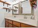 Bathroom featuring double sinks, wooden cabinets, and decorative mirrors offering convenience and style at 494 Asset Pkwy, Sanford, NC 27332