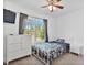 Bedroom featuring natural light from the window, carpet flooring, and a ceiling fan at 494 Asset Pkwy, Sanford, NC 27332