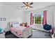 Cozy bedroom featuring carpeted floors, a ceiling fan, and lots of natural light at 494 Asset Pkwy, Sanford, NC 27332