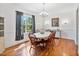 Classic dining room with hardwood floors, a large window, and a chandelier, creating an elegant atmosphere at 494 Asset Pkwy, Sanford, NC 27332