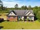 An aerial shot captures the front elevation of a charming home with a landscaped yard at 494 Asset Pkwy, Sanford, NC 27332