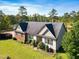 Aerial view of a two-story home with a spacious yard, brick details, and well-maintained landscaping at 494 Asset Pkwy, Sanford, NC 27332