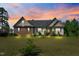 Charming home featuring brick and vinyl siding, complemented by a well-maintained lawn, showcasing classic design elements at 494 Asset Pkwy, Sanford, NC 27332