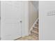 Hallway door view showcases neutral tile flooring and stairway access at 494 Asset Pkwy, Sanford, NC 27332