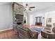 Bright living room with a stone fireplace, modern ceiling fan, and hardwood floors offering a cozy atmosphere at 494 Asset Pkwy, Sanford, NC 27332