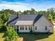The rear exterior of a bright two-story home shows multiple windows and a well maintained lawn at 494 Asset Pkwy, Sanford, NC 27332