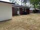 Back exterior view of the house with a brick facade, white trim, and a spacious backyard at 502 Burton St, Fuquay Varina, NC 27526