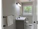 Modern bathroom with grey vanity, sleek fixtures, and a window with a view at 502 Burton St, Fuquay Varina, NC 27526