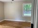Bedroom with hardwood floors, a ceiling fan, and a window view of the outdoors at 502 Burton St, Fuquay Varina, NC 27526