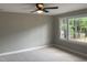 Neutral bedroom featuring plush carpet and large windows with outdoor views at 502 Burton St, Fuquay Varina, NC 27526
