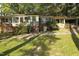 Quaint single-story home featuring a brick facade, a well-manicured lawn, and a welcoming front porch at 502 Burton St, Fuquay Varina, NC 27526