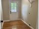 Spacious laundry room with hardwood floors, natural light, and convenient access to the backyard at 502 Burton St, Fuquay Varina, NC 27526