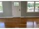 Bright living room featuring newly refinished hardwood floors, fresh paint and large windows at 502 Burton St, Fuquay Varina, NC 27526