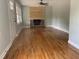 Spacious living room featuring hardwood floors, a fireplace, and fresh paint at 502 Burton St, Fuquay Varina, NC 27526