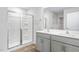 Bright bathroom with a dual sink vanity, a glass enclosed shower and wood-look flooring at 505 Lochalsh Dr, Gibsonville, NC 27249