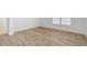 Comfortable bedroom with light-colored, wood-look flooring and a large window at 505 Lochalsh Dr, Gibsonville, NC 27249