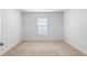 Bright, carpeted bedroom with a window, offering a simple and functional space at 505 Lochalsh Dr, Gibsonville, NC 27249