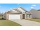 Home exterior showcasing a brick and siding combination, attached garage, and concrete driveway at 505 Lochalsh Dr, Gibsonville, NC 27249