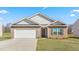 Charming brick home with an attached garage, manicured lawn, and lovely landscaping at 505 Lochalsh Dr, Gibsonville, NC 27249
