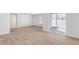 Open living room with sliding glass doors leading to outdoor patio and light wood-look flooring at 505 Lochalsh Dr, Gibsonville, NC 27249