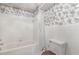Bathroom featuring a tub, shower, toilet, and floral wallpaper, creating a functional space at 5062 Dorsey Rd, Oxford, NC 27565
