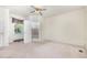 Spacious bedroom with an ensuite bathroom, ceiling fan, and natural light from the window at 5062 Dorsey Rd, Oxford, NC 27565