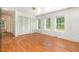 Bedroom with hardwood floors, double closets, and several windows at 5062 Dorsey Rd, Oxford, NC 27565