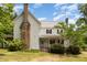 Two-story home showcasing a stone chimney, covered porch and ample outdoor charm at 5062 Dorsey Rd, Oxford, NC 27565