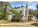 Two-story home with a rustic stone chimney and a covered front porch offering curb appeal at 5062 Dorsey Rd, Oxford, NC 27565