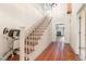 Interior view of the foyer, staircase with lift system, and hardwood floors leading to the living room at 5062 Dorsey Rd, Oxford, NC 27565