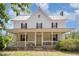 Exterior front porch showcasing white railing, columns, and a swing for relaxing outdoors at 5062 Dorsey Rd, Oxford, NC 27565