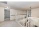 Second-floor hallway with staircase, carpet, and access to bedrooms at 5062 Dorsey Rd, Oxford, NC 27565