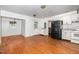 Eat-in kitchen features white cabinets, laminate countertops, and black refrigerator at 5062 Dorsey Rd, Oxford, NC 27565