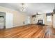 Spacious living room featuring hardwood floors, a charming fireplace, and ample natural light at 5062 Dorsey Rd, Oxford, NC 27565