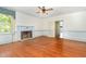 Living room with fireplace and hardwood floors with view into another room at 5062 Dorsey Rd, Oxford, NC 27565