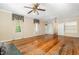 Bright living room featuring a fireplace, hardwood floors and ample natural light through large windows at 5062 Dorsey Rd, Oxford, NC 27565