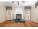 Charming living room showcasing a brick fireplace, hardwood floors, and inviting ambiance at 5062 Dorsey Rd, Oxford, NC 27565