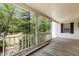 Inviting porch with a view of mature trees, railing, providing a serene outdoor space at 5062 Dorsey Rd, Oxford, NC 27565
