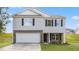 Two-story home features stone accents, a two-car garage, and professional landscaping at 522 Lochalsh Dr, Gibsonville, NC 27249